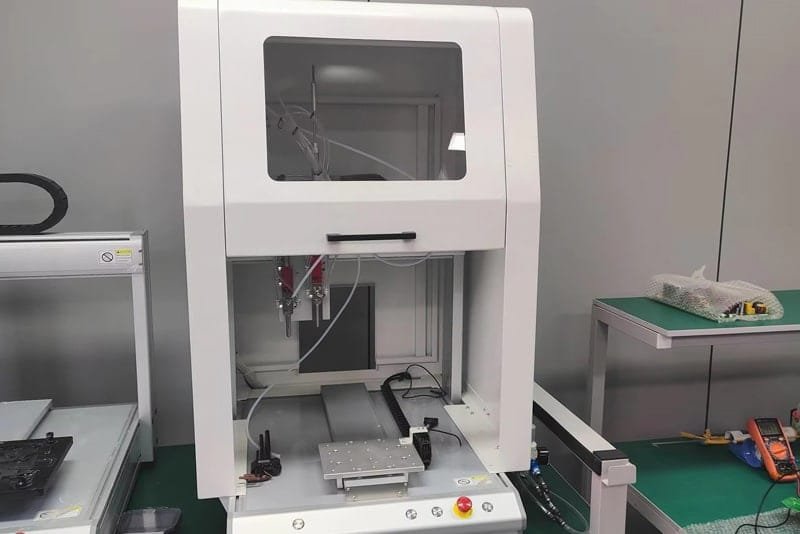Precision five-axis dispensing machine for automated adhesive application at Peka Power