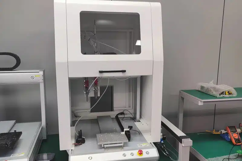 Precision five-axis dispensing machine for automated adhesive application at Peka Power