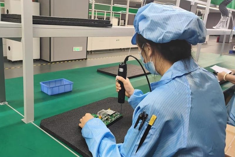 Peka Power technician assembling and testing electronic circuit components during production