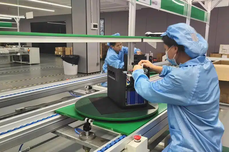 Peka Power staff assembling internal components of a portable power station on the production line