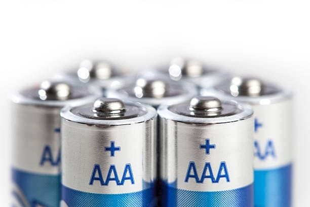 Close-up view of AAA batteries showing smaller size compared to AA