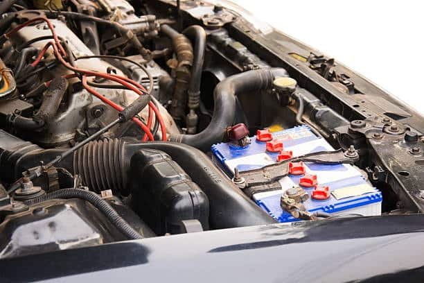 Car battery properly installed in engine bay showing no signs of leak