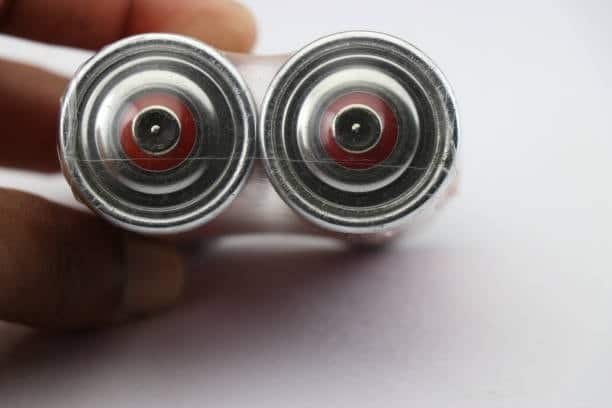 Close-up of two AA batteries connected side by side for voltage increase