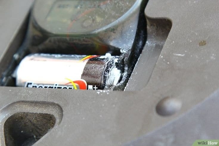 White powder residue around leaking AA battery indicating acid smell