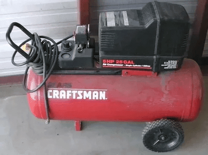 Red Craftsman air compressor with wheels and a powerful 5 HP motor.