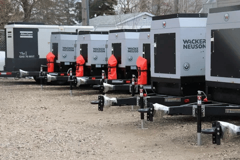 Multiple portable diesel generators aligned in a row for industrial and construction site use