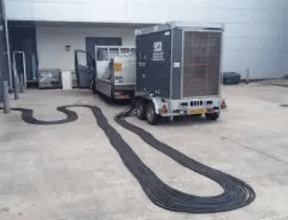 Trailer-mounted generator with long distribution cables for site power supply