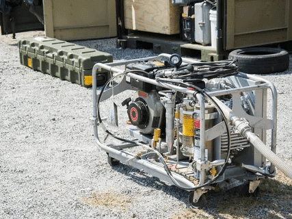 Silver portable generator placed outdoors for powering appliances and tools.