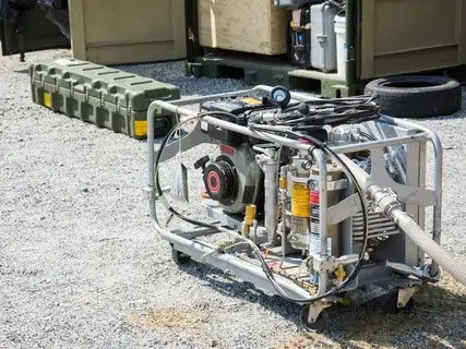Silver portable generator placed outdoors for powering appliances and tools.