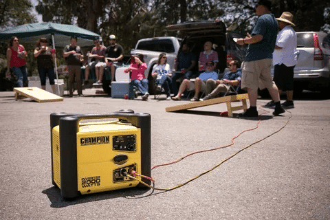 Yellow Champion 2000 watt inverter generator connected at an outdoor party.