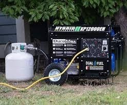 Portable dual fuel generator connected to propane tank for power generation.
