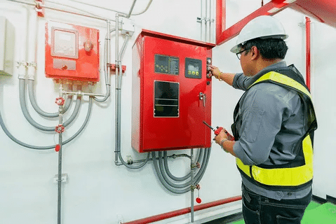 Engineer checking diesel generator control panel during NFPA 110 testing