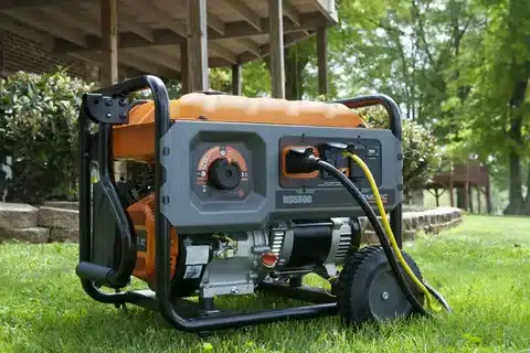 Portable generator on lawn providing backup electricity for house.
