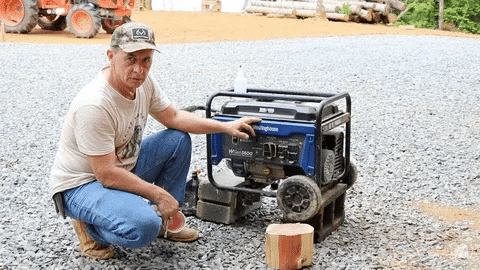 Technician showing oil maintenance steps for a portable generator.