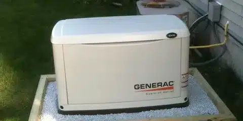 Outdoor standby generator positioned with adequate clearance from walls for safe operation.