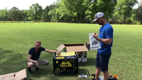 Two men setting up a Champion 7500 watt generator outdoors